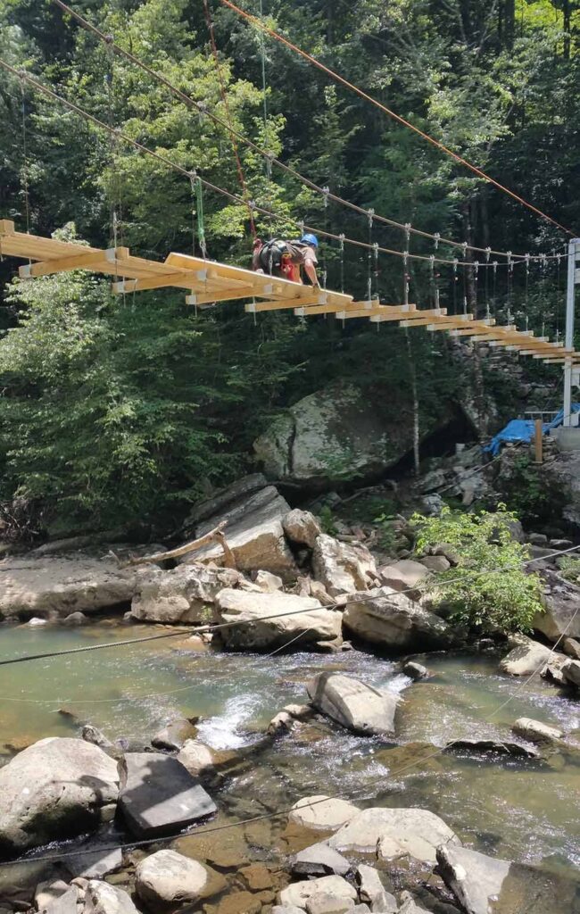 Tethered with a safety line, a worker secures treads to the Big Soddy Bridge during the summer of 2015